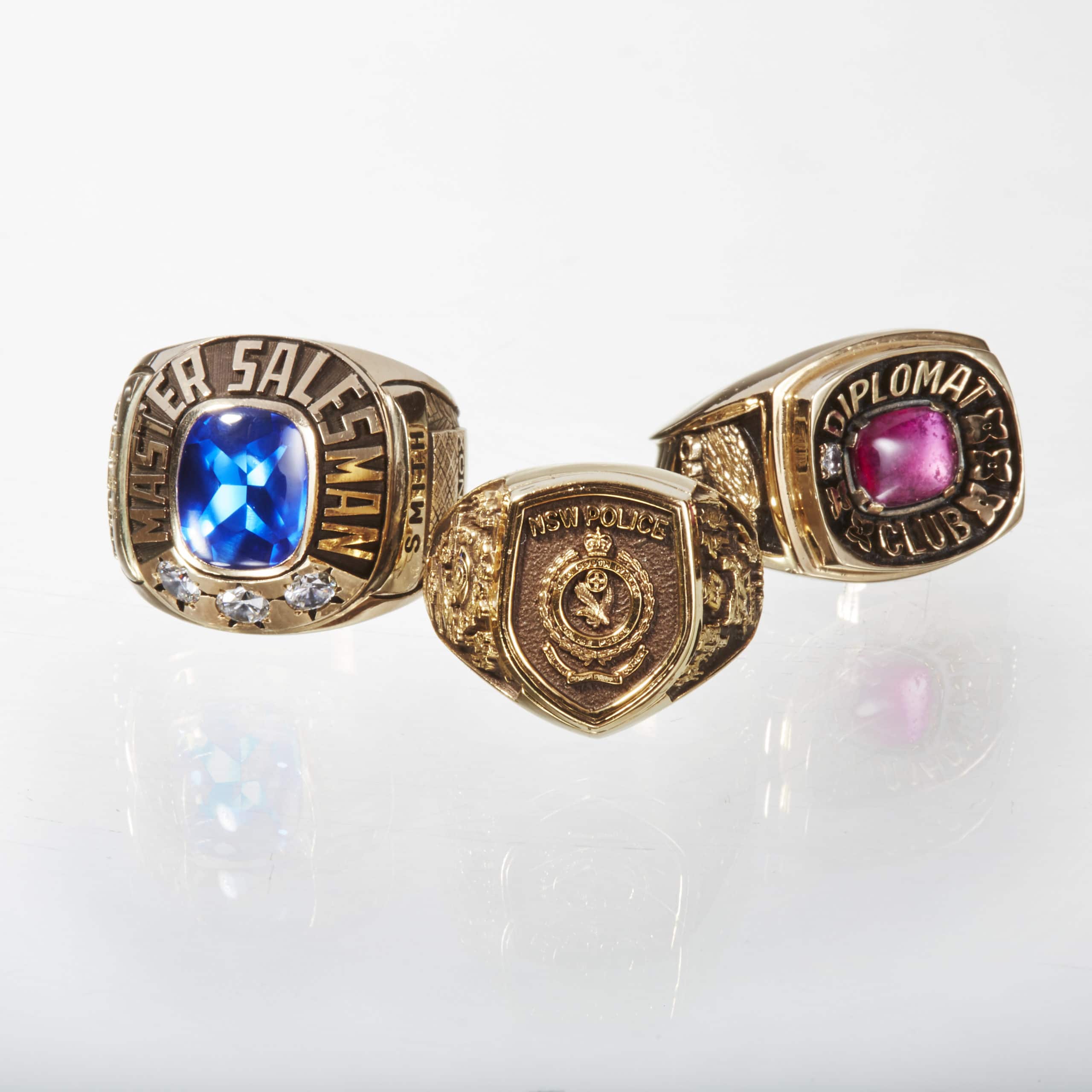 Three Class Rings with Blue and Pink Stones